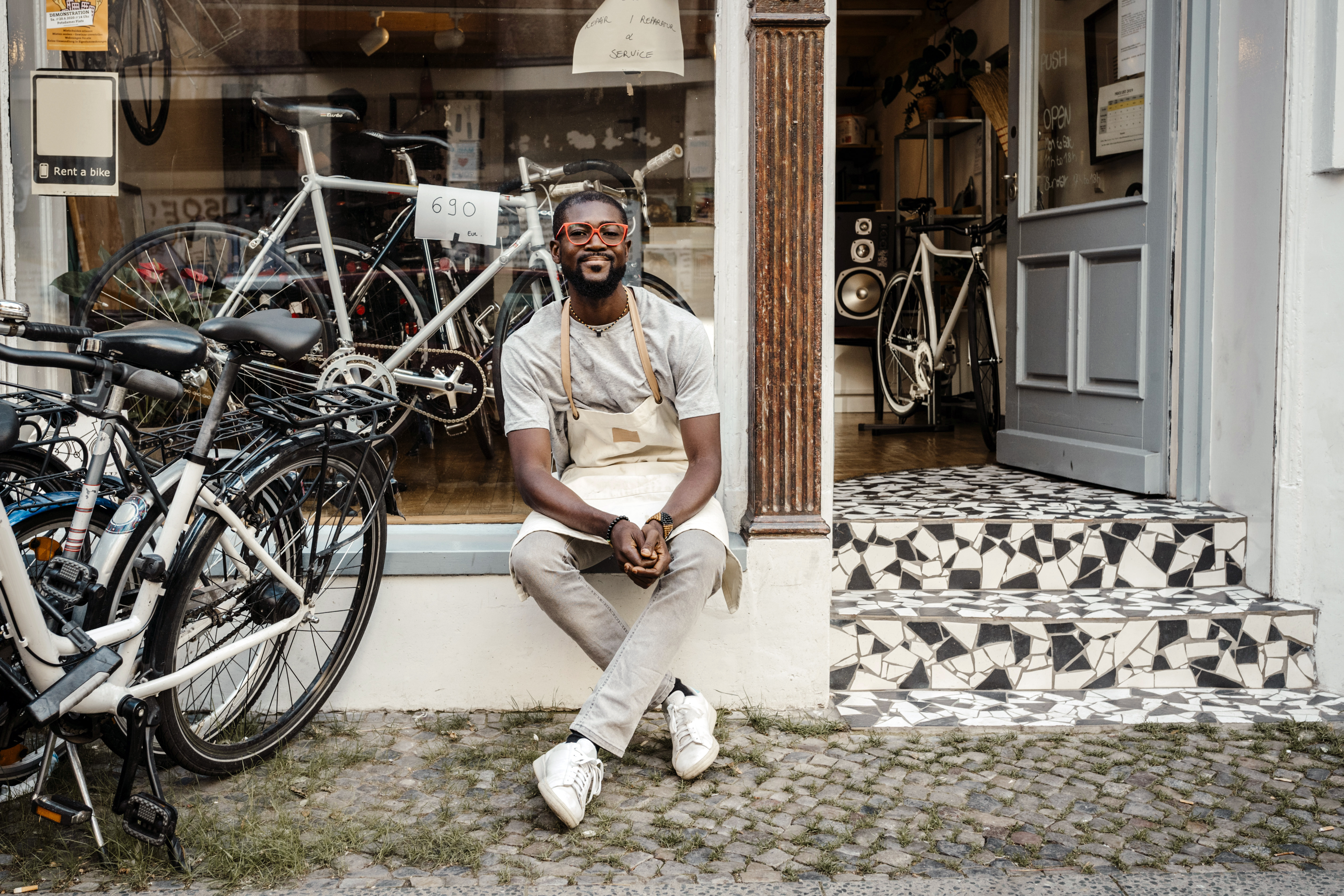 Business owner outside his bike shop